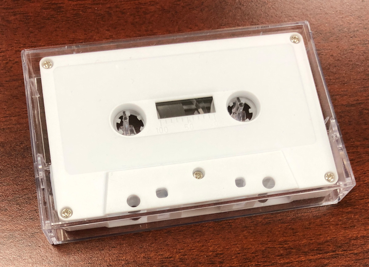 retro white cassette and norelco case